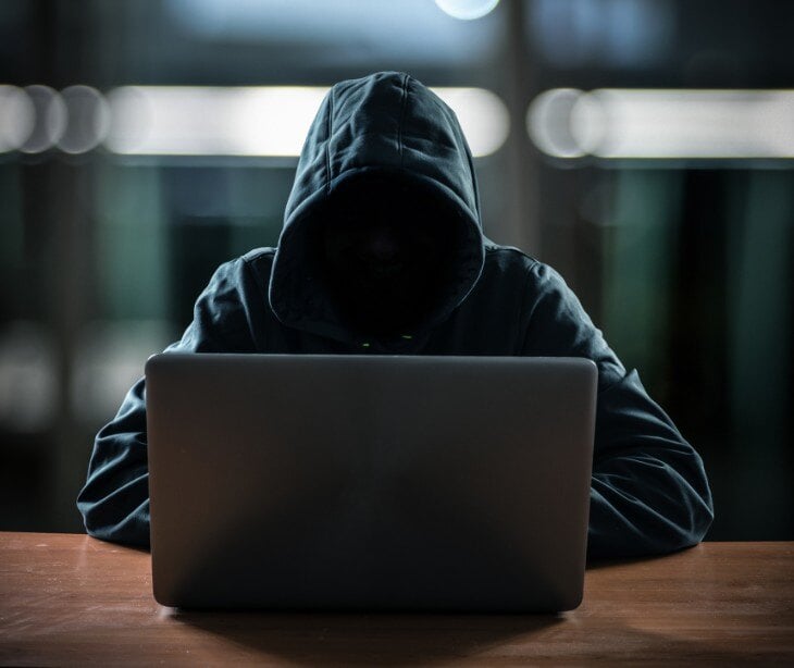 Image of someone on a computer for blog about Understanding the difference between TTPs and IoCs in cybersecurity