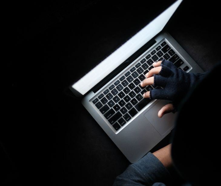 gloved hand on laptop