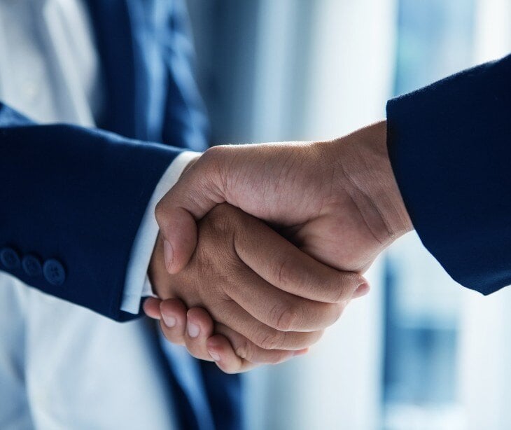 Image of two people's hands shaking. 