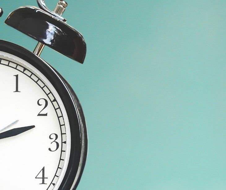 Image of a clock with a green background.